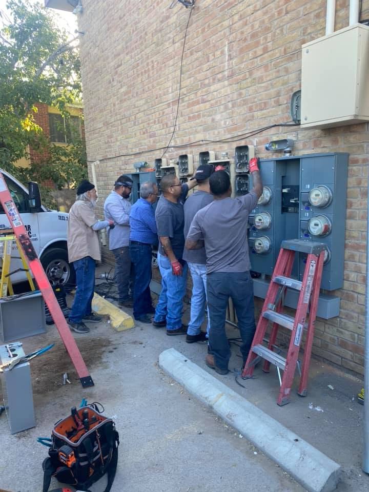 Tovar Electric crew working on outside electrical panels